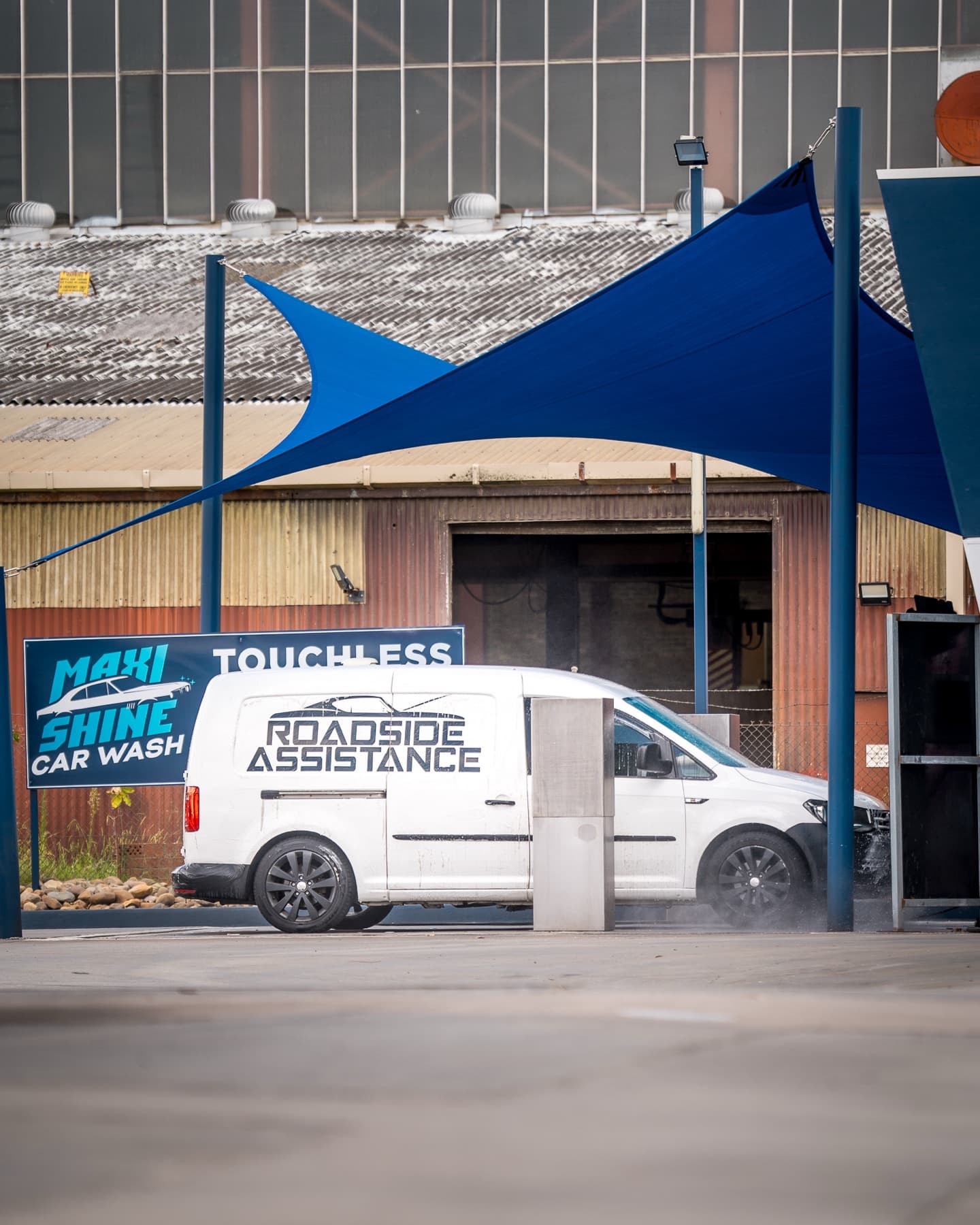 A white Roadside Assistance van at a Maxishine touchless bay